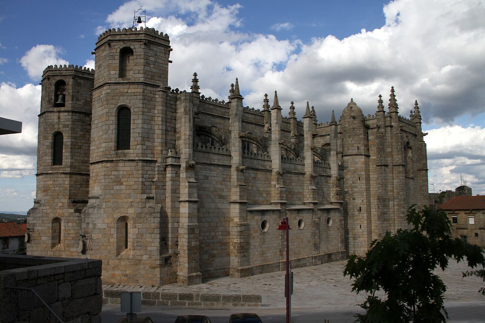 Granite cathedral with towers and pinnacles, on a day with white clouds