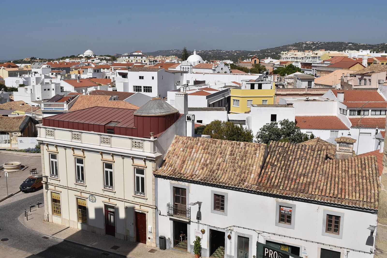 Rooftops and white houses of Loulé, with hills in the background