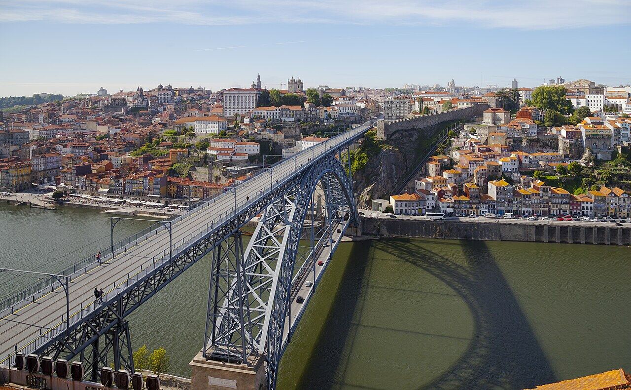 Two-deck steel bridge over the Douro river, with Porto houses on the hillside