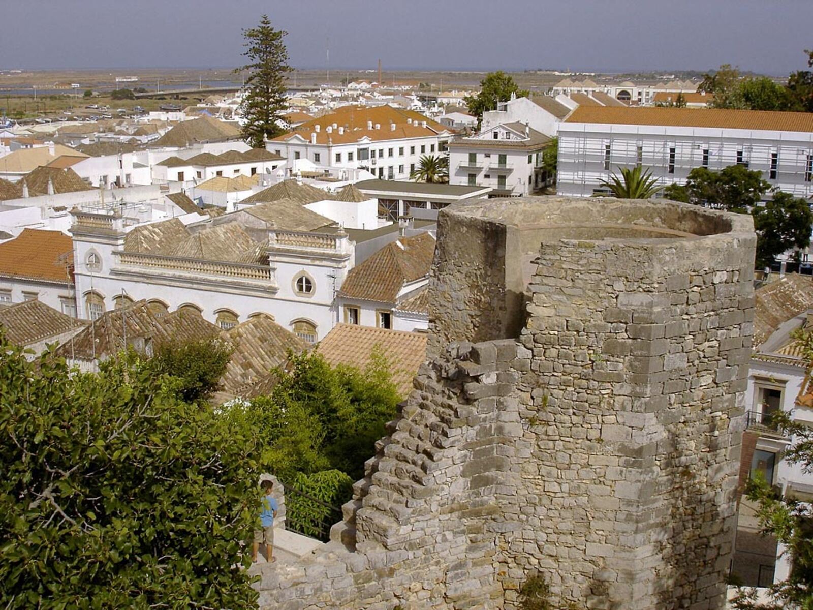 White houses with old tiled roofs in Tavira, seen from a tower of the castle wall